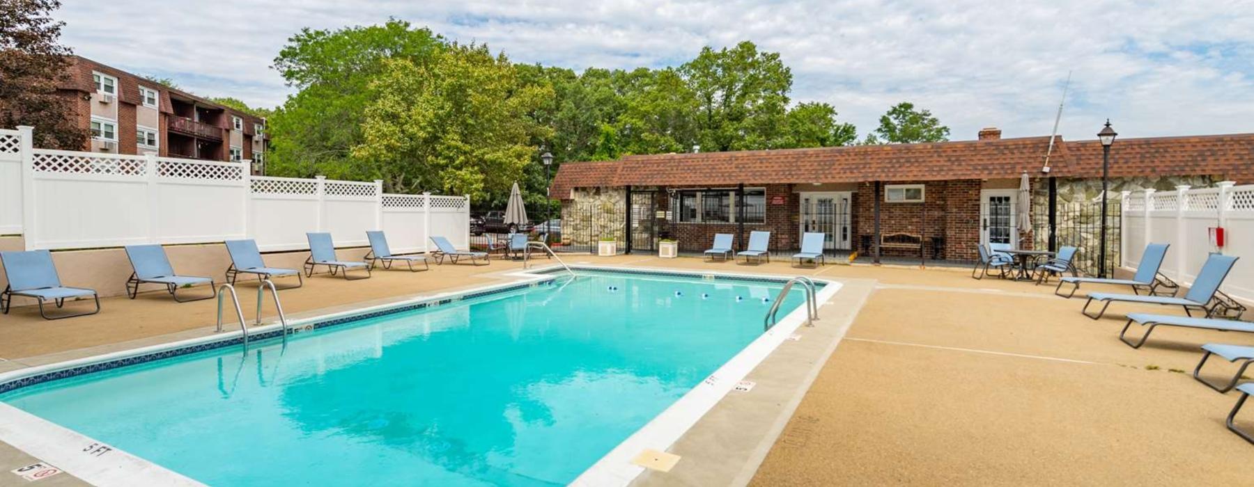 a swimming pool with chairs around it