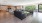 a large living room with a wood floor and a wood floor