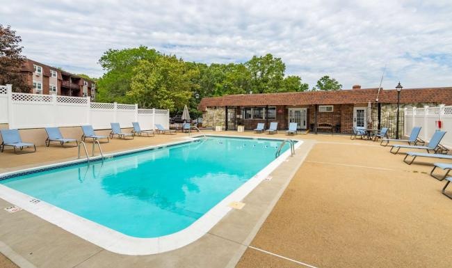 a swimming pool with chairs around it