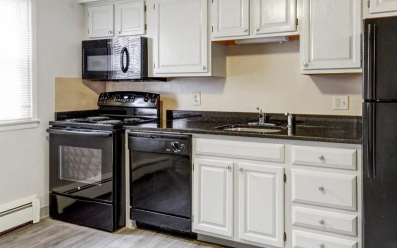 a kitchen with white cabinets
