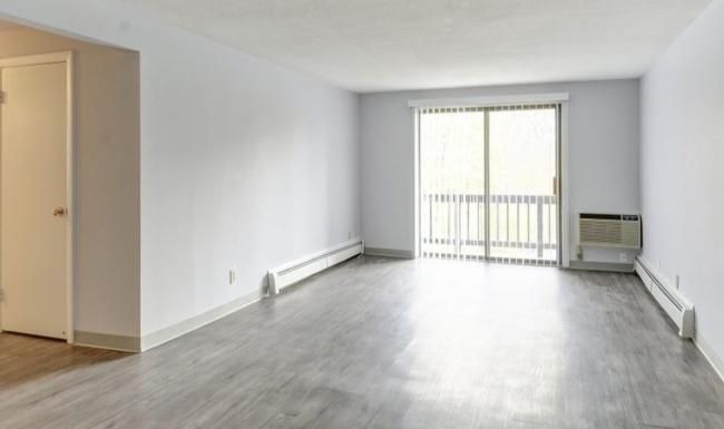 a room with a wood floor and window