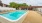a swimming pool with chairs around it